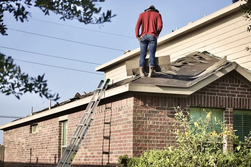Professional roofer working on a residential roof in Lafayette